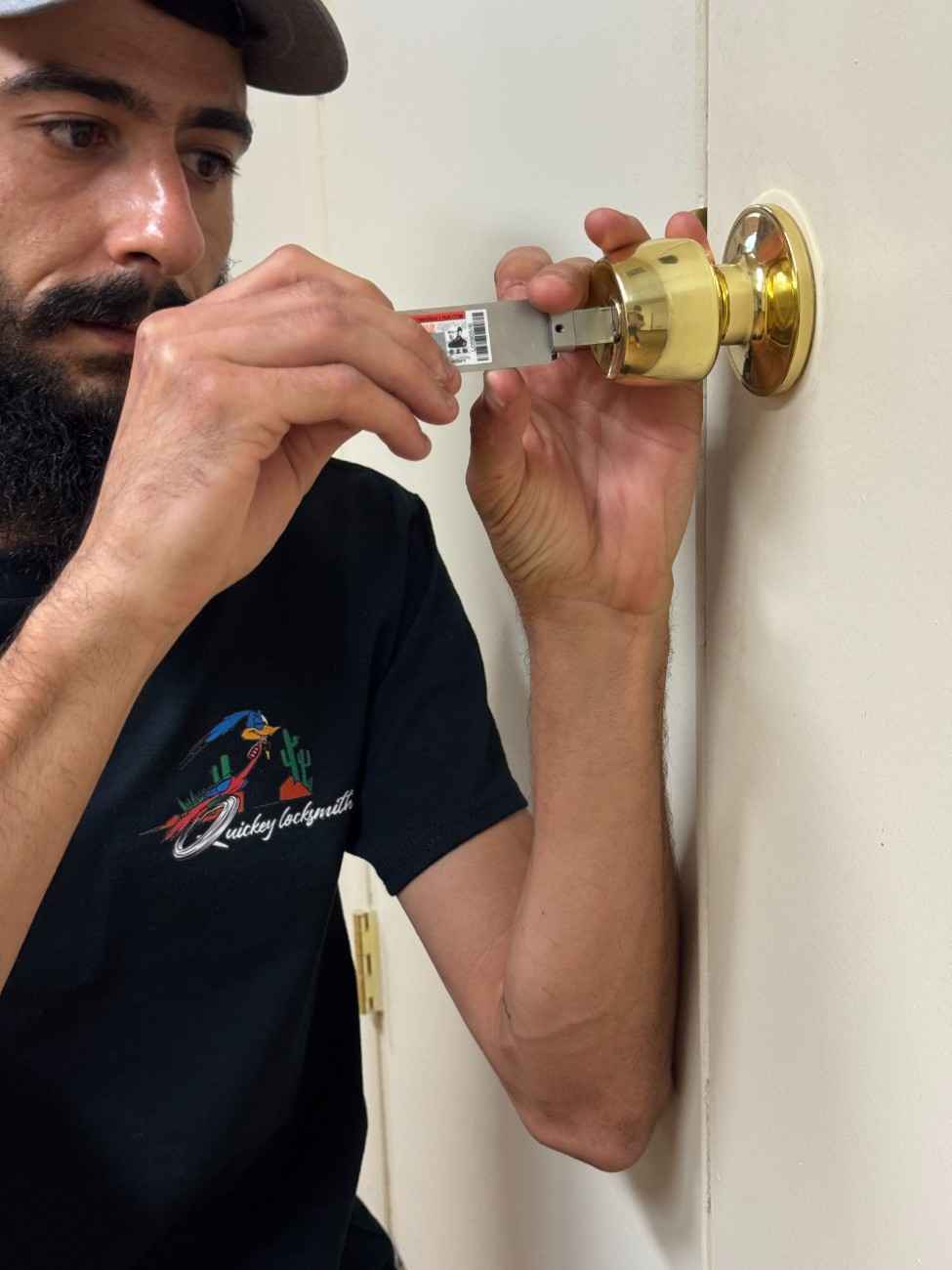QuicKey technician repairing a brass residential door knob